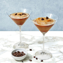 Load image into Gallery viewer, Two martini glasses filled with a layered dessert on a marble surface with coffee beans.
