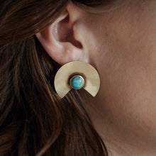Load image into Gallery viewer, Close-up of a gold earring with a turquoise gemstone worn by a person.