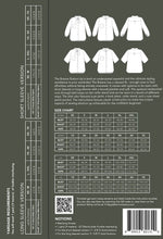 Load image into Gallery viewer, Back of a shirt packaging with size chart and QR code on a gray background