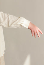 Load image into Gallery viewer, White long-sleeve garment with a blurred background