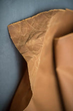 Load image into Gallery viewer, Close-up of brown leather texture on a dark background