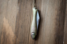 Load image into Gallery viewer, Fishing lure shaped like a fish with a pocket knife on a wooden surface