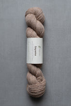 Load image into Gallery viewer, Ball of yarn with a label on a gray background