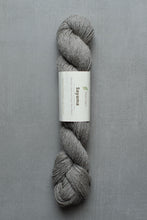 Load image into Gallery viewer, Gray skein of yarn with a label on a gray background