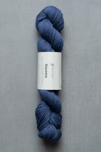 Load image into Gallery viewer, Blue skein of yarn with a label on a gray background