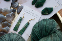 Load image into Gallery viewer, Green earrings on a card with yarn and stones in the background