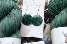 Load image into Gallery viewer, Green marbled earrings on a card with yarn in the background