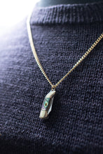 Load image into Gallery viewer, Necklace with a pendant on a dark textured fabric background