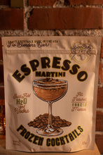 Load image into Gallery viewer, Packaging of Espresso Martini frozen cocktails with branding and cocktail illustration on a brick background.