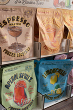 Load image into Gallery viewer, Assorted frozen cocktail packages on a shelf with branding and product names.