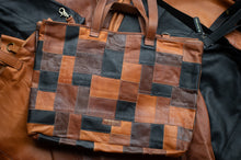 Load image into Gallery viewer, Patchwork leather bag with brown and black squares on a dark surface
