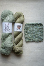 Load image into Gallery viewer, Two skeins of green yarn and a knitted swatch on a light gray background
