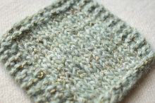 Load image into Gallery viewer, Close-up of a knitted fabric swatch in a textured pattern on a light background