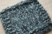 Load image into Gallery viewer, Knitted fabric in a textured pattern on a beige background