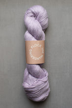 Load image into Gallery viewer, Lavender skein of yarn with a label on a gray background