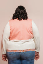 Load image into Gallery viewer, Person wearing a peach vest over a white shirt with blue jeans on a beige background