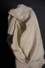 Load image into Gallery viewer, White textured fabric draped over a black background