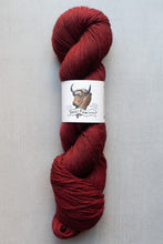 Load image into Gallery viewer, Red skein of yarn with a label featuring a bear design on a light gray background