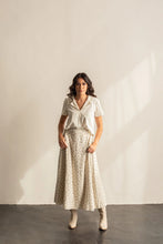 Load image into Gallery viewer, Woman wearing a white blouse and patterned skirt against a plain background