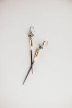 Load image into Gallery viewer, Pair of earrings with gold accents and blue beads on a light background