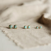 Load image into Gallery viewer, Turquoise stud earrings on a beige fabric background