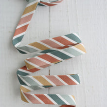 Load image into Gallery viewer, Colorful striped ribbon on a white wooden surface