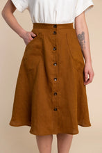 Load image into Gallery viewer, Brown button-up skirt worn by a person on a beige background