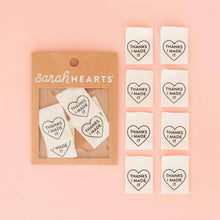 Load image into Gallery viewer, Heart-shaped stickers with 'Thanks I Made It' text in a 'Sarah Hearts' packaging on a pink background