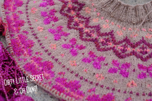 Load image into Gallery viewer, Close-up of a knitted sweater showing a Fair Isle style pattern with bright magenta and pink motifs on a taupe-gray base, with a ribbed crew neck visible at the top and a watermark reading 'DIRTY LITTLE SECRET &amp; OH DANG!' in the lower left.