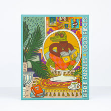 Load image into Gallery viewer, Colorful puzzle box with a design of a frog reading a book, featuring the brand 'Birdie Puzzles'.