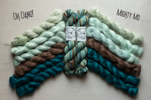 Load image into Gallery viewer, Two braided skeins of yarn displayed side by side on a neutral fabric background, labeled 'OH DANG!' and 'MIGHTY MO'. The left skein is made of mint green, medium brown, and deep teal yarns.