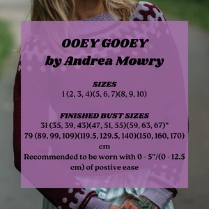 Purple label with text about 'OOEY GOOEY by Andrea Mowry' clothing sizes and measurements.