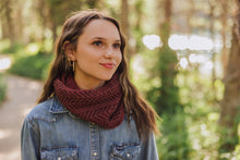 Load image into Gallery viewer, Woman wearing a maroon knitted scarf in a forest setting