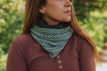 Load image into Gallery viewer, Woman wearing a green knitted scarf with a blurred natural background