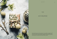 Load image into Gallery viewer, Gift-wrapped box with floral design on a marble surface with decorative elements.