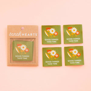 Packaging of 'Good Things Take Time' stickers by Sarah Hearts on a pink background