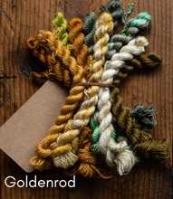 Load image into Gallery viewer, Color swatch of yarn in various shades on a wooden surface with 'Goldenrod' text.