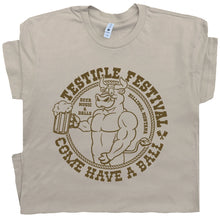 Load image into Gallery viewer, Beige t-shirt with graphic design of a muscular dog holding a beer mug and text 'TESTICLE FESTIVAL COME HAVE A BALL'.