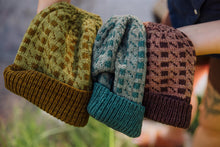 Load image into Gallery viewer, Three knitted hats in different patterns held together with a blurred natural background