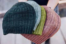 Load image into Gallery viewer, Four knitted hats in green, blue, green, and brown held together.