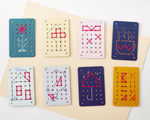 Load image into Gallery viewer, Set of embroidered cards with various designs on a beige background