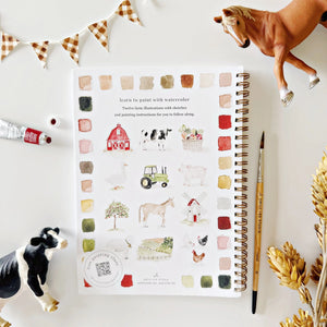Notebook with farm-themed illustrations on a white surface with decorative elements.