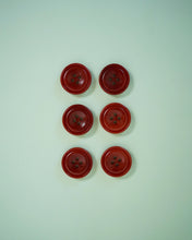 Load image into Gallery viewer, Five red buttons with four holes on a light green background