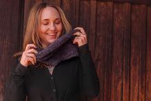 Load image into Gallery viewer, Woman adjusting a purple scarf against a wooden background