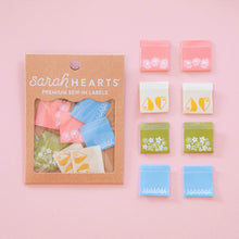 Load image into Gallery viewer, Packaging of 'sarah HEARTS' premium sew-in labels on a pink background