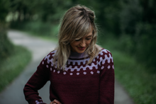 Load image into Gallery viewer, Woman wearing a patterned sweater standing on a path with greenery in the background