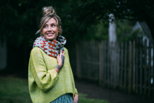 Load image into Gallery viewer, Woman wearing a green sweater and patterned scarf outdoors