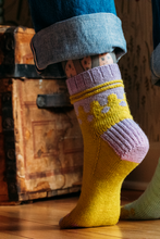 Load image into Gallery viewer, Colorful knitted socks with a pattern worn by a person on a wooden floor.