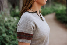 Load image into Gallery viewer, Person wearing a light gray sweater with striped sleeves in a forest setting