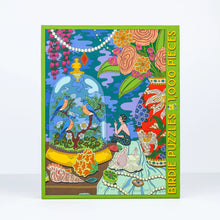 Load image into Gallery viewer, Colorful puzzle box with a design of birds, flowers, and a woman sitting, featuring the brand 'Birdie Puzzles'.